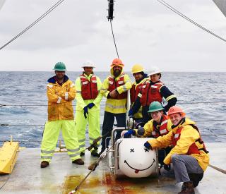 Samer Naif, left, with fellow researchers in the field (offshore New Zealand, for a separate research study). 